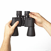 Hands adjusting eyepiece of binoculars
