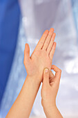 Woman massaging palm using thumb-walking technique