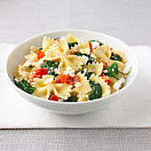 Farfalle pasta with spinach and ricotta in bowl