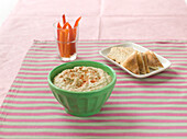 Baba ghanoush served in bowl on striped tablecloth