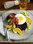 Black pudding with apples, leeks, fried egg and bacon