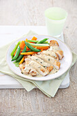 Chicken escalope in lemon sauce with carrots and mangetout