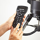 Finger pressing button on telescope keypad handset