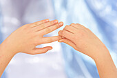 Woman massaging index finger using thumb-walking technique