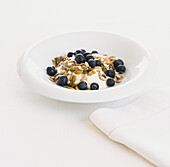 Bowl of fromage frais topped with seeds and blueberries