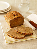 Gluten free basic brown loaf on chopping board