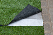 Artificial turf being laid with one corner turned back