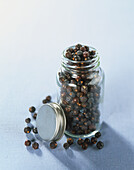 Whole dried Juniper berries in glass jar