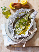 Fish baked in foil with lemon, fennel and olive oil