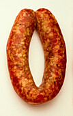 Reddish brown and yellow mottled length of Toulouse sausage