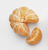 Plump ripe peeled segments of tangerine