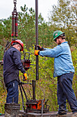 Workers plugging an abandoned oil well