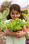 Girl holding a potted lettuce