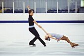 Ice skating couple performing death spiral
