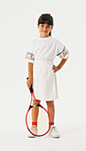 Girl in a tennis whites holding a tennis racket