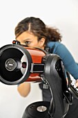 Woman looking through go-to telescope