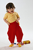 Baby pulling up trousers