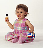 Girl sitting and playing with toys