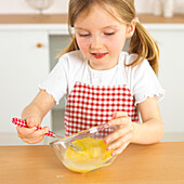 Girl holding fork in bowl with eggs in