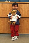 Boy holding teddy