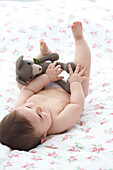 Baby boy holding a crocheted bear