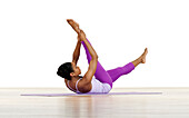 Woman practising Pilates mat exercise