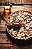 Pear pie with whiskey on a wooden background