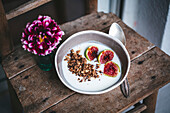 Breakfast bowl of yogurt, granola and fresh figs