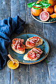 Bruschetta with raw ham and blood oranges
