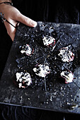 Chocolate truffles with dark icing and white sprinkles