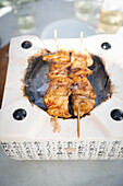 Chicken skewers on a hibachi grill