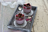 Vegan raspberry chocolate nougat dessert in a glass