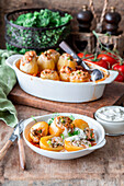 Baked stuffed potatoes with chicken and peas