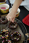 Chocolate banana donuts with colorful sugar pearls