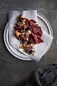 Moose carpaccio with blackberry syrup and chanterelles