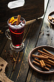 Mulled wine with citrus slices and cinnamon sticks