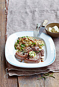 Deer steak with herb butter and mushroom pudding