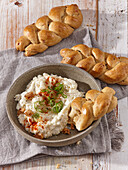 Cheese spread with braided bread rolls