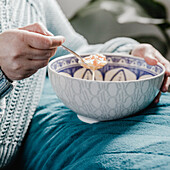 Bowl of vegetable soup in a blue and white pattern bowl