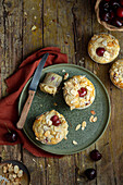 White chocolate muffins with cherries and flaked almonds