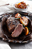 Roasted duck breast served with pear and orange