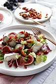 Nuts and raisins salad with goat cheese and grapes