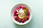 A smoothie bowl with silken tofu, raspberries and dragon fruit