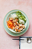 A Vietnamese banh mi bowl with chicken, radishes and cucumber