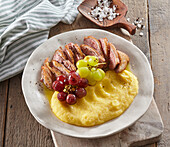 Duck breast with grapes and polenta