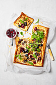 Puff pastry tart with blue cheese, pear, grapes, walnuts and cranberry sauce