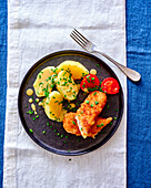 Breaded hake with potatoes and chives