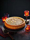 A cheesecake with a spider web pattern for Halloween