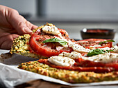 Broccoli pizza with tomatoes and mozzarella