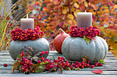 Pumpkins as candle holders with a wreath of peony fruit stalls